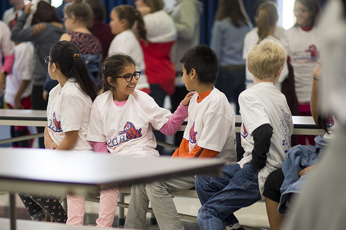 Two students wearing t-shirt and talking