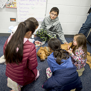 Students with dog on the floor