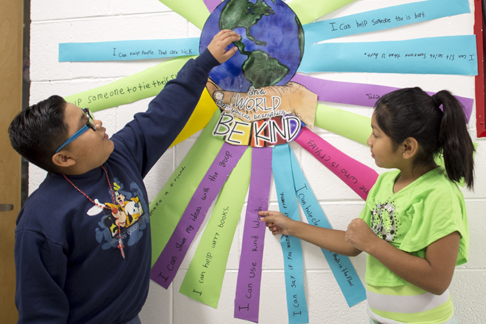 Children pointing at wall art