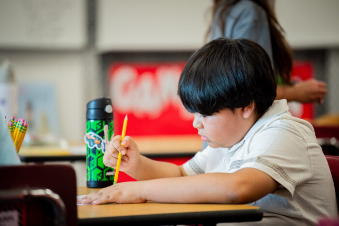Student working on assignment in the classroom.